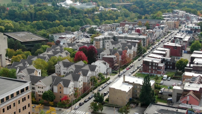 Aerial of urban American city housing. Diversity of architecture with old and modern homes, apartments, condos in USA. Colorful autumn fall foliage in USA.