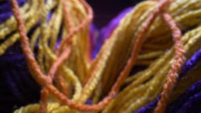 The multi colored wool yarn is close up to show the detailed texture. Vertically sliding camera moving along a bright rainbow yarn. Dolly super macro shot. - Powered by Shutterstock - Get 15% off with code: PIKWIZARD15