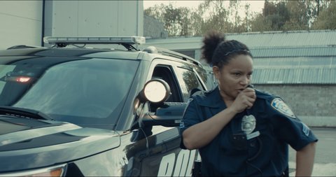 African-American black driver is being pulled off by mixed-race female police officer. Documents check, speeding ticket. Shot on RED cinema camera with 2x Anamorphic lens