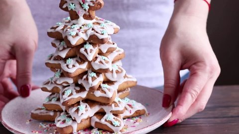 Christmas and New Year concept. The process of decorating a Christmas gingerbread. Gingerbread in the form of a Christmas tree. Soft focus.