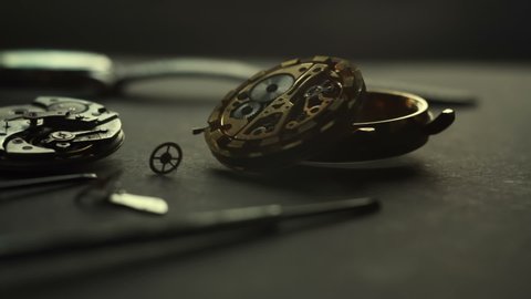 Slow motion panorama of Watchmaker workshop, disassembled mechanical watch, special repair tool