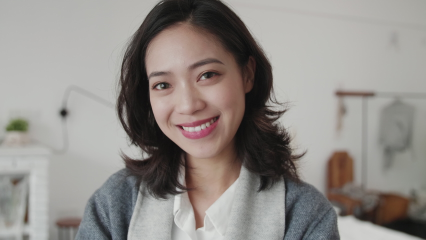 Portrait of lovely young Chinese woman smile at camera close up of one beautiful Asian woman smile at camera indoor Royalty-Free Stock Footage #1061311522