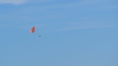 People are resting flying on parasailing in the sky, outdoor activities.