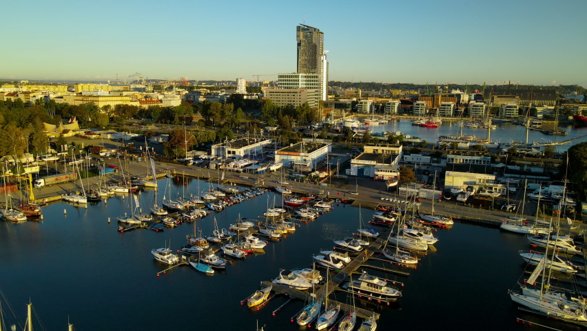 Gdynia City Port Panoramic View - Modern Sea Towers And Skyscrapers With Sailboats And Yachts Docked At The Baltic Coast Of Poland. - Aerial Shot