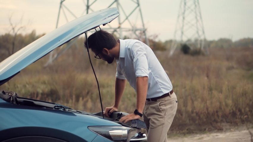 Frustrated Businessman Repairing Accident Car.Sad Disappointed Man On Broken Car.Vehicle Check Engine Damage Troubles.Car Engine Overheating.Auto Failure Accident Inspection.Open Hood Automobile Motor Royalty-Free Stock Footage #1061321305