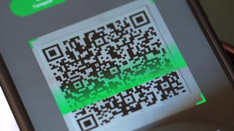 Scanning a QR code. Smartphone screen close up. The app scans the QR code. Checking the QR code of the vaccination certificate