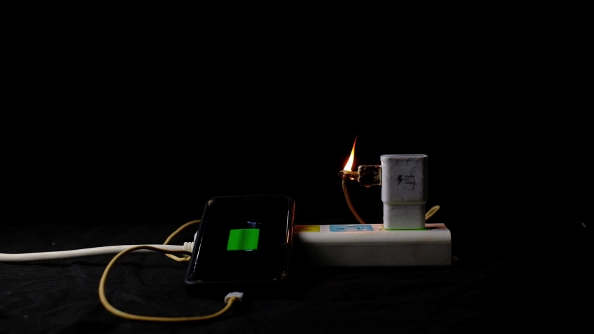 Power supply adapter burns with fire while mobile phone on recharge | Shutterstock HD Video #1061329120