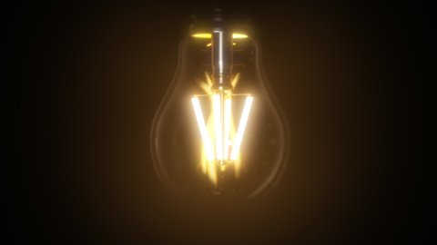 Switching on, turning off light bulb animation. Warm yellow light over dark black background. Bright glowing and flickering Edison, Tungsten lamp. Retro vintage form. Creative idea concept. 3D 4K clip