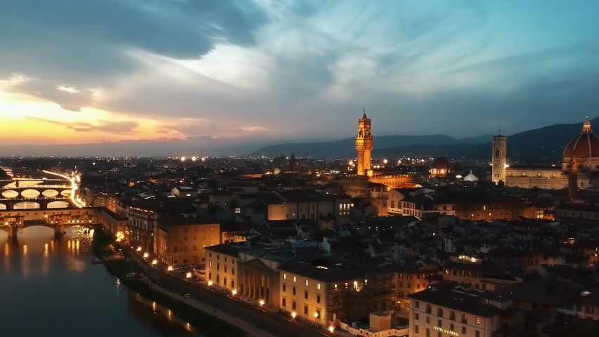 Establishing aerial view of Florence  Old City, Florence Duomo Cathedral, Firenze Cattedrale di Santa Maria del Fiore, Florence Ponte Vecchio in Firenze, Florence, Italy at dusk Royalty-Free Stock Footage #1061333845