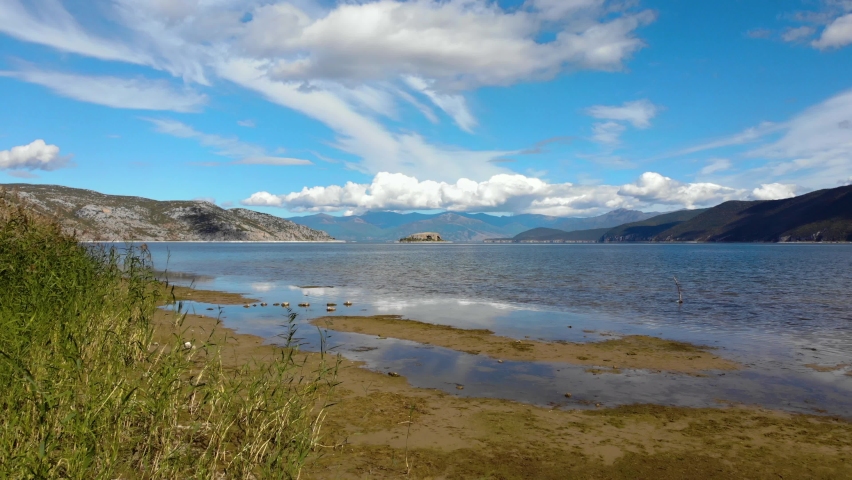 Natural lake of Prespa in high Balkan mountains with small island in the middle at Autumn