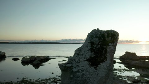 Pan aerail shot of Rauks sea stacks, limestones, in Gotland, Sweden,