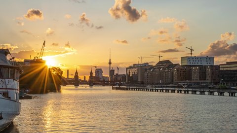 Beautiful view of Berlin skyline with famous TV tower and Oberbaum Bridge at river Spree in golden evening light at sunset, Berlin Friedrichshain-Kreuzberg, Germany