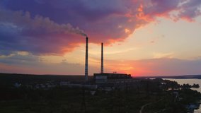 Power plant by sunset in the landscape with lake. Timelapse video.