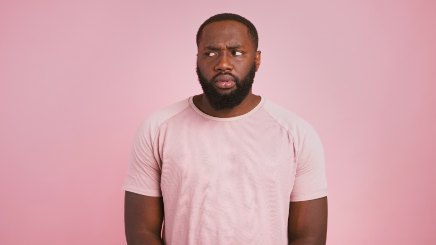 So what. African american man raising his hands, waiting for excusement, pink studio background Royalty-Free Stock Footage #1061371444