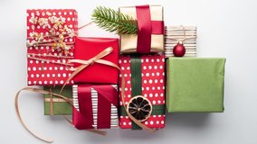 Wrapping Christmas gifts step by step on a white background. Time-lapse video. Stop motion video. New Year and Christmas. - Powered by Shutterstock - Get 15% off with code: PIKWIZARD15