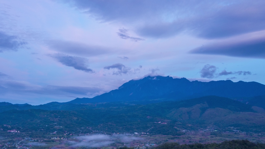Time lapse sunrise MOUNT KINABALU, moving clouds over a villages. Taken at RANAU, SABAH, BORNEO. time lapse motion zoom out