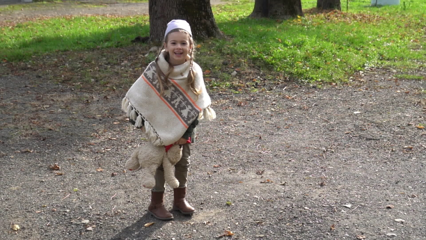 Little girl outdoor with teddy bear alone. Orphanage life. Autumn activities for kids.