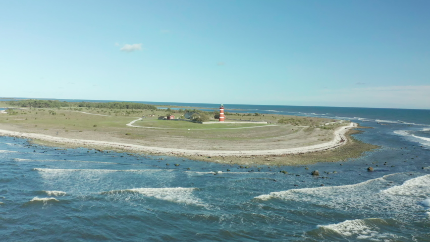 Närsholmen Desolate lighthouse on the island of Gotland, Sweden, aerial footage flying over a bautiful coastal area