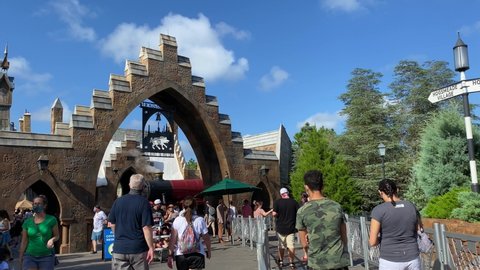 Orlando, FL/USA - 10/18/20:  The exterior of the Hogsmeade a Harry Potter themed area at Universal Studios in Orlando, Florida with people wearing face masks and social distancing.