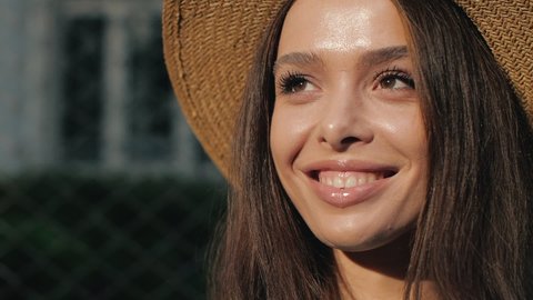 Close up of Woman’s Face, Girl opening her Beautiful Eyes, while looking at the Sun. Latino-American Female. Natural Beauty, Gorgeous Woman with long Eyelashes enjoying warmly sunny Day. Cute Smile.