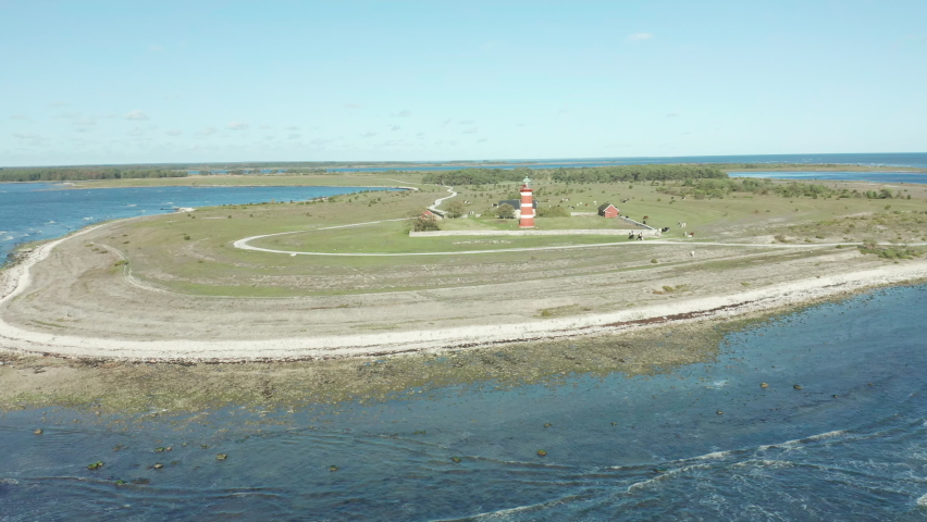 Desolate lighthouse on Närsholmen, Gotland, aerial footage flying over sea in bautiful coastal area