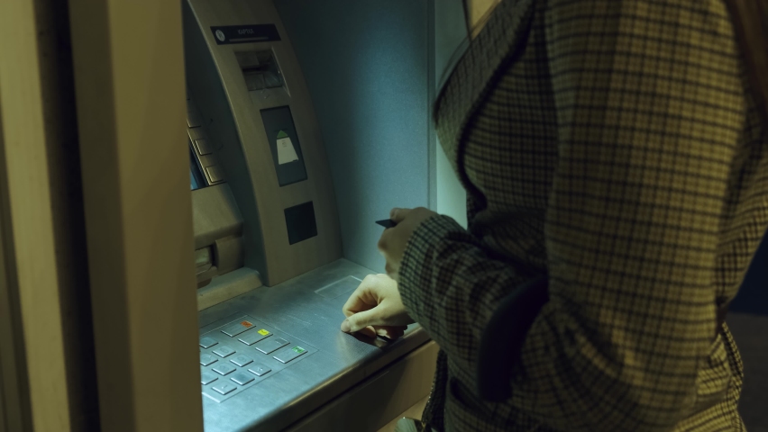 Woman using ATM to withdraw money. Girl near bank terminal getting cash. Banking service, transfer and cash withdrawal concept Royalty-Free Stock Footage #1061389837