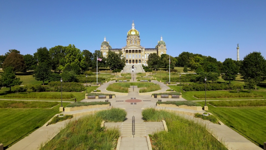 Drone aerial footage flying up to Iowa State Capitol building in Des Moines on sunny day
