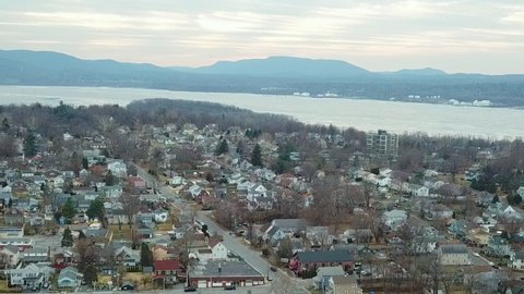 Drone footage of Beacon, New York in the Hudson Valley in winter with the Hudson River in the background.