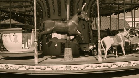 Old wooden carousel in Arles, France, sepia video