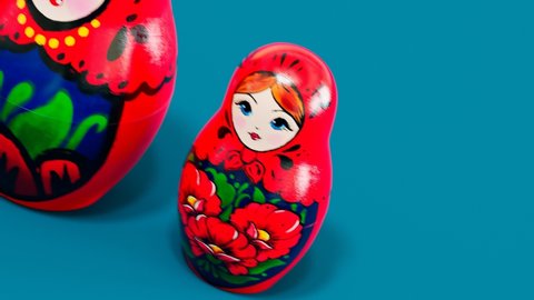 Beautiful handmade matryoshka dolls. Seamless looping animation of smaller babushka jumping out from the bigger one. Cute traditional wooden Russian toys. Souvenirs painted with colourful ornaments.
