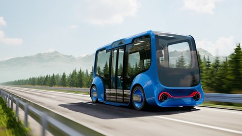 An autonomous electric smart bus coming up the road in a mountain surrounding. Moder minibus. Electric car going to charge station. Concept of the environment-friendly car.Green fuel. Electromobility
