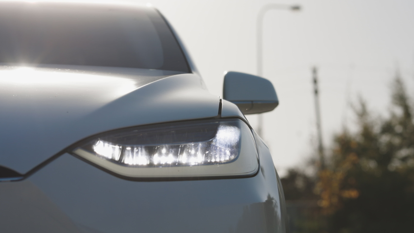 Car with Headlight Flashing Smoothly Close up. Car Front Led Light with a Blurry Background and a Nice Colour. Car Headlights Flashing Led Lamp. Royalty-Free Stock Footage #1061406889