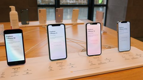 Paris, France - Oct 23, 2020: Low angle view of the new iPhone 11, 12 and iPhone 12 Pro on display during launch day in Apple Store nest to SE model. Latest 5G smartphones go on sale worldwide.