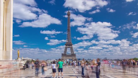 Famous square Trocadero with Eiffel tower in the background timelapse hyperlapse. Trocadero and Eiffel tower are the most visited attractions of Paris. Blue cloudy sky at summer day
