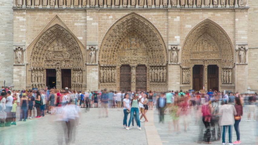 Entrance to Notre-Dame de Paris timelapse with people staying in long queue. It is a medieval Catholic cathedral on the Cite Island in Paris, France. Sunny summer day