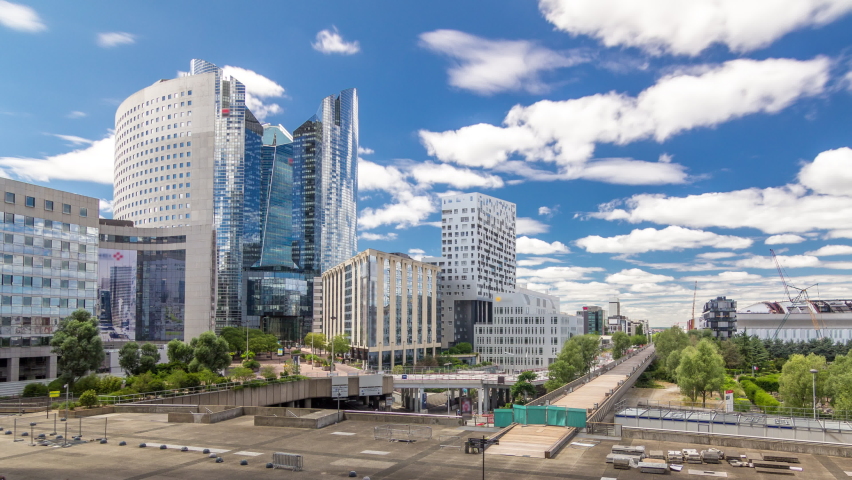 Skyscrapers of Defense timelapse hyperlapse modern business and financial district in Paris with highrise buildings. View from Grande Arche. Blue cloudy sky in summer day. Reflections in modern towers Royalty-Free Stock Footage #1061418163