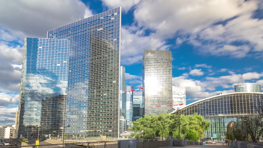 Skyscrapers of Defense timelapse hyperlapse modern business and financial district in Paris with highrise buildings and convention center. View from bridge. Blue cloudy sky in summer day. Reflections Royalty-Free Stock Footage #1061418166
