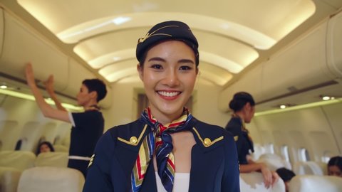 Cabin crew or air hostess working in airplane . Airline transportation and tourism concept.