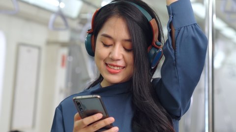 Young woman mobile phone on public train . Urban city lifestyle commuting concept .