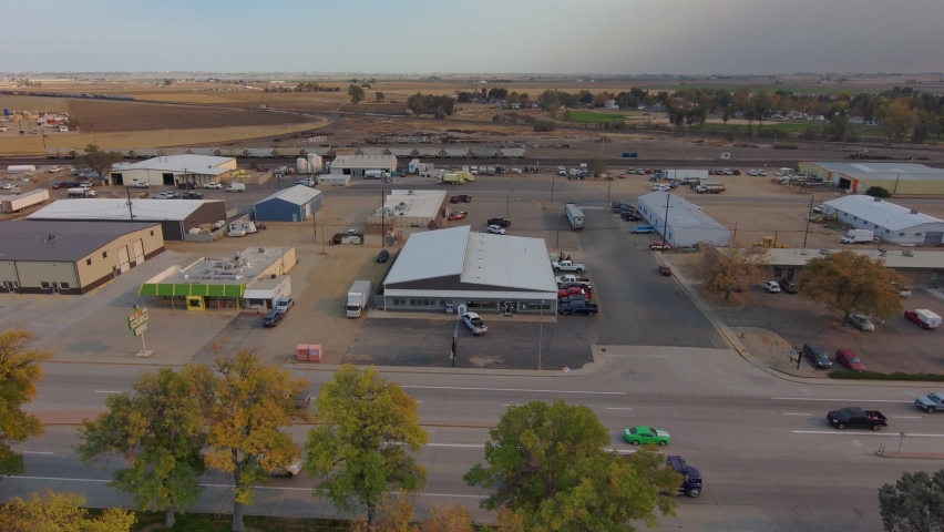 A descending establishing shot of an industrial park in rural America.