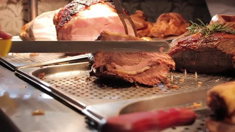 Chef Carving A Beef Joint At A Sunday Carvery