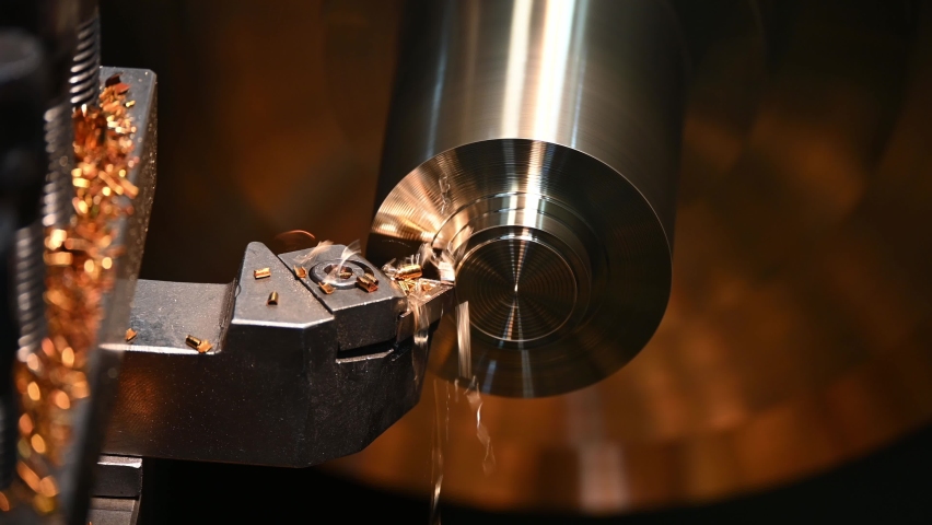 Close-up 4K scene operation of lathe machine cutting the brass shaft parts and the cutting chips. The metalworking process by turning machine. Royalty-Free Stock Footage #1061428381