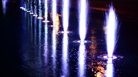 Beautiful musical fountain with colorful illumination in the evening in Kiev Ukraine 4k video