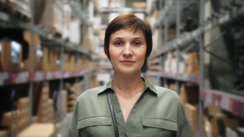 Portrait of Female entrepreneur, small business owner, warehouse worker, manager, preparing working in shipping delivery warehouse. Royalty-Free Stock Footage #1061429500