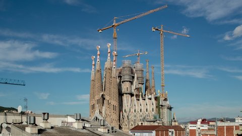 looping forward and reverse time lapse footage of the cathedral Sagrada Familia on a beautiful cloudy day in Barcelona, Spain