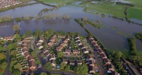 Overhead footage of flooded fields next to residential property in England, UK