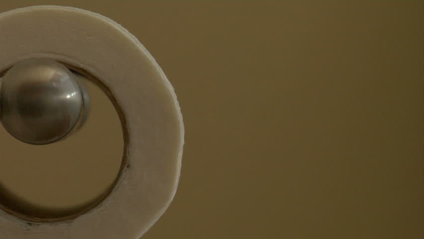 close up of a roll of toilet paper unrolling