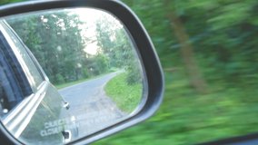 Mirror of a driving car view, road and green nature landscape, summer day 4k video