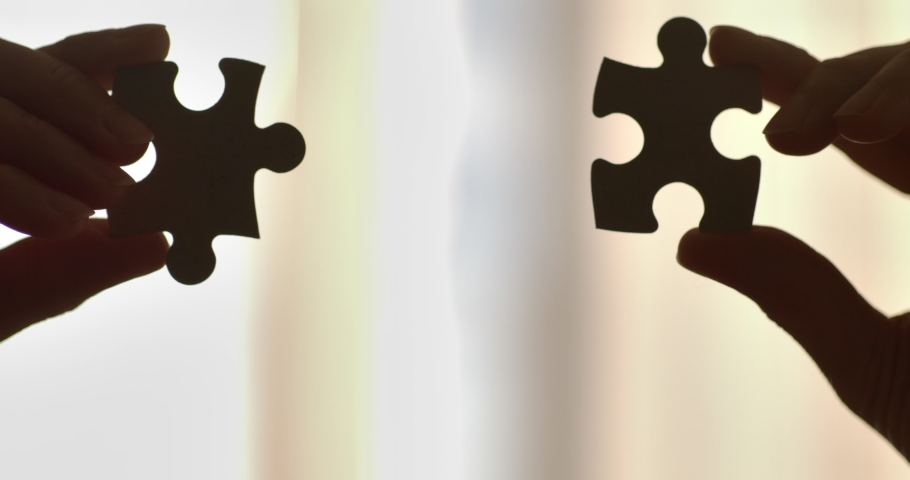 Close Up Hands of Woman Connecting Jigsaw Puzzle With Sunlight Affect. Business Solutions, Success Strategy. Two Hands Connect Couple Puzzle. One Part of Whole Symbol of Association and Connection. Royalty-Free Stock Footage #1061448097