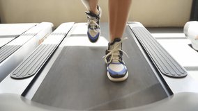 Close-up video of legs running on the treadmill, sport and fitness concept. Cardio training in gym.